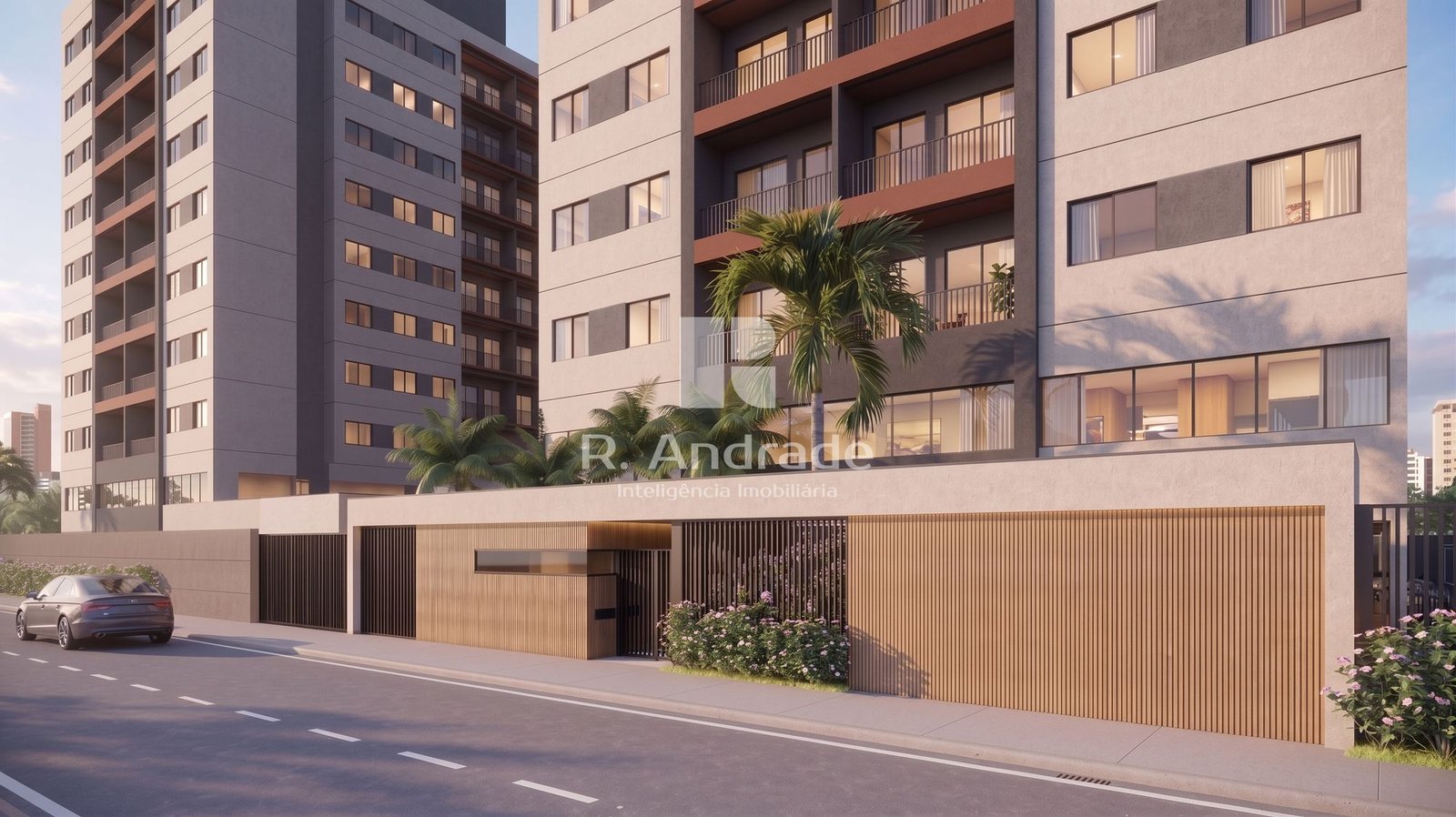 Perspectiva da fachada e da portaria do condomínio, com prédios de varanda, palmeiras e muro com painel de madeira